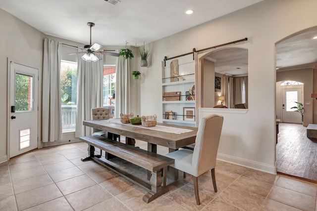 tiled dining space with ceiling fan