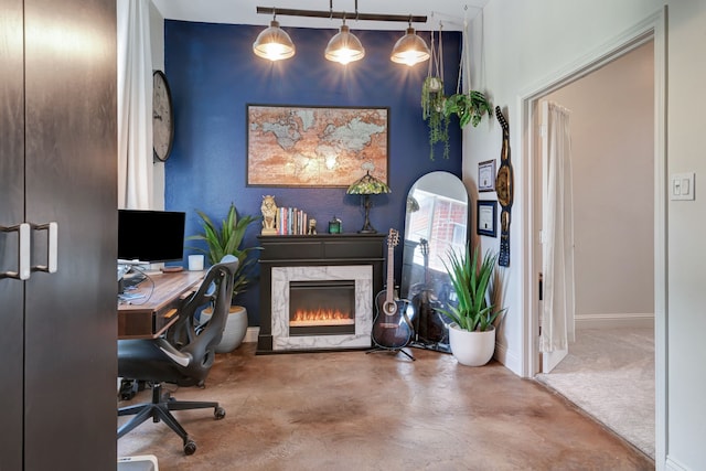 office featuring a fireplace and concrete floors