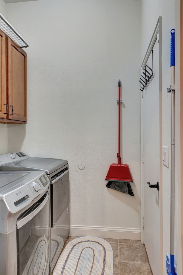 washroom with light tile patterned floors, cabinets, and independent washer and dryer