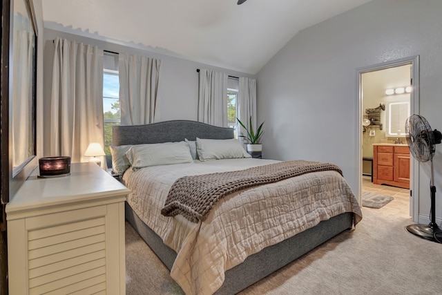 carpeted bedroom with lofted ceiling and connected bathroom