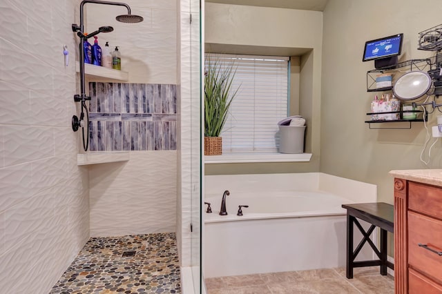 bathroom featuring vanity and separate shower and tub