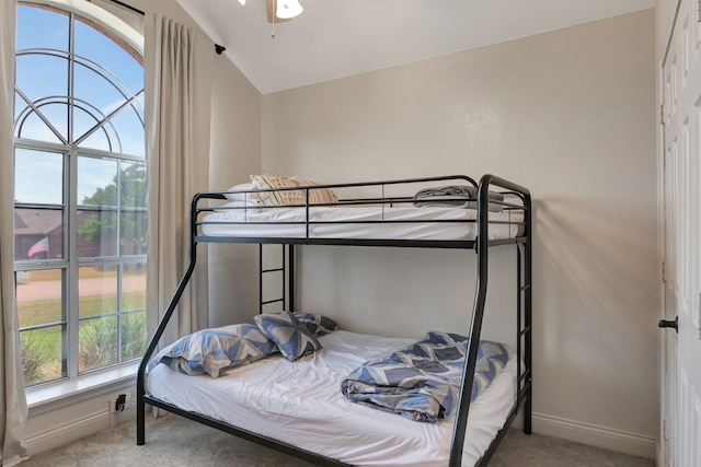 carpeted bedroom featuring lofted ceiling