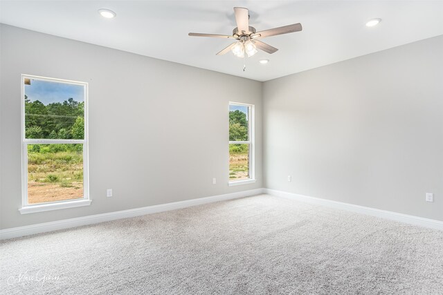 carpeted empty room with ceiling fan