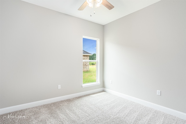 unfurnished room with ceiling fan and carpet flooring