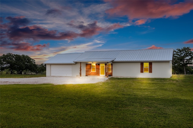 view of front of home featuring a garage and a yard