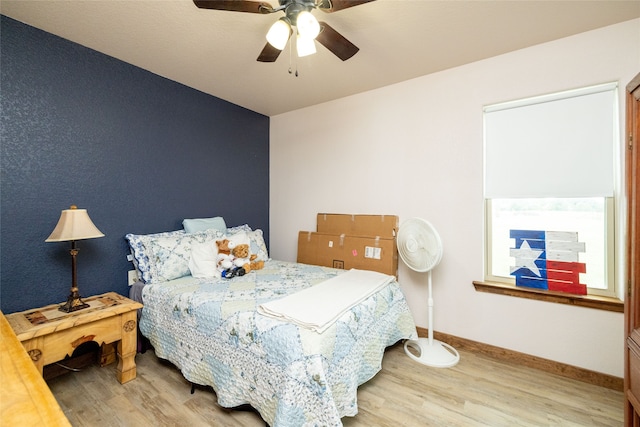 bedroom with ceiling fan and hardwood / wood-style floors