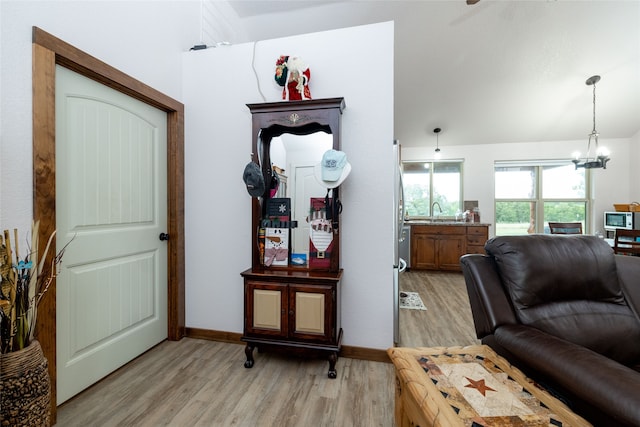 interior space with a chandelier, light hardwood / wood-style flooring, and sink