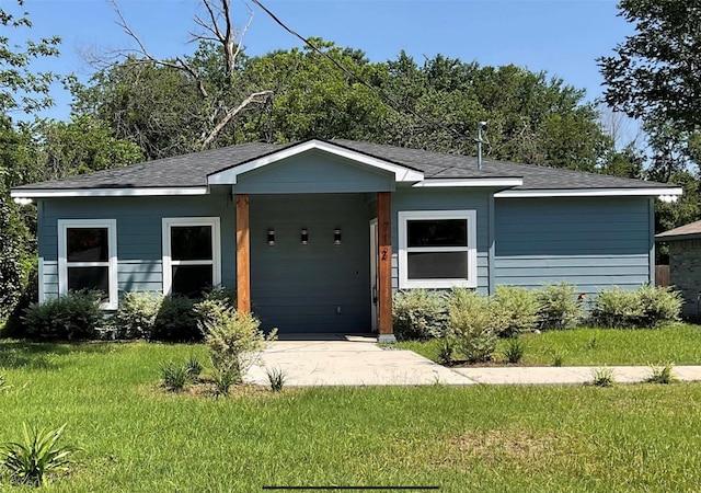 view of front of property with a garage and a front yard