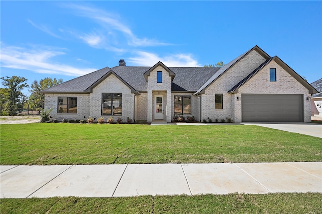 view of front of house featuring a front yard and a garage