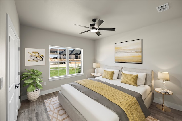 bedroom with a closet, ceiling fan, and hardwood / wood-style floors