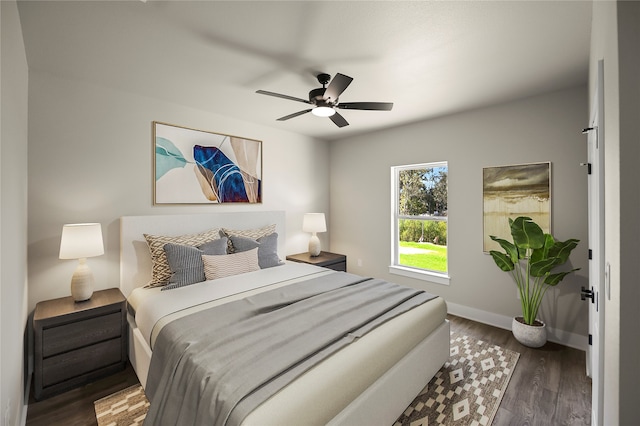 bedroom with ceiling fan and dark wood-type flooring