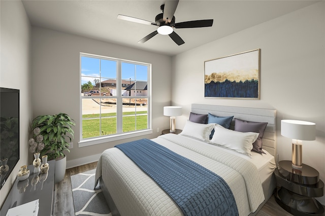 bedroom with dark hardwood / wood-style flooring and ceiling fan