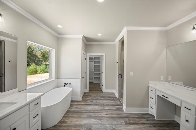 bathroom featuring hardwood / wood-style flooring, vanity, crown molding, and plus walk in shower