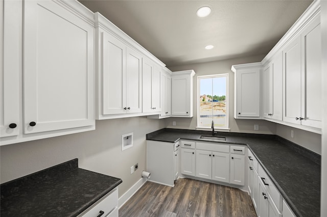 clothes washing area featuring cabinets, washer hookup, dark hardwood / wood-style flooring, and sink