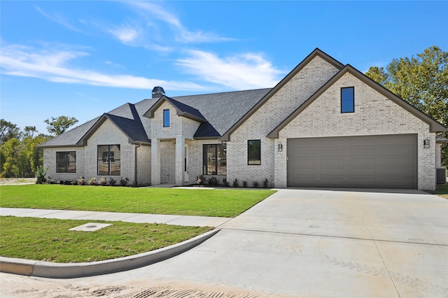 view of front of home with a garage and a front yard