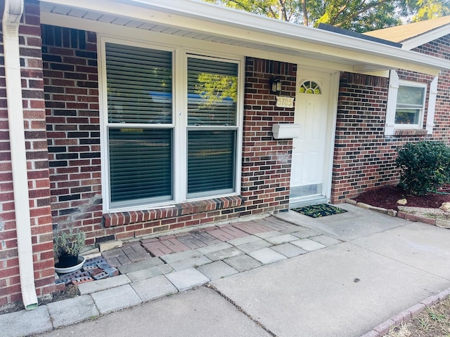 view of exterior entry featuring a porch