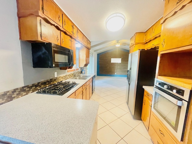 kitchen with light tile patterned flooring, sink, and black appliances