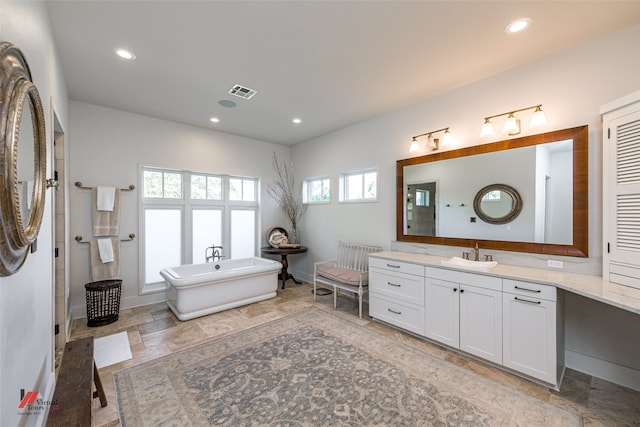 bathroom featuring a bathing tub and vanity