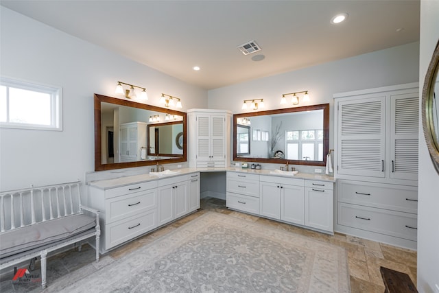 bathroom with tile patterned flooring and dual vanity