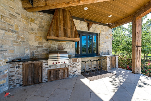 view of patio / terrace featuring sink, a grill, and exterior kitchen