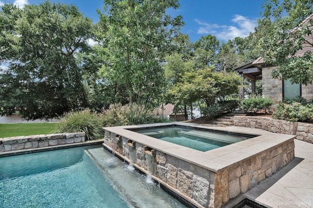 view of pool featuring an in ground hot tub