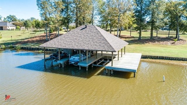 dock area with a water view and a yard