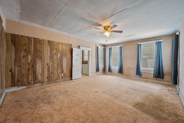 unfurnished bedroom with ceiling fan and carpet