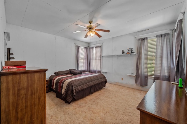 bedroom featuring light carpet and ceiling fan