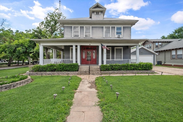 farmhouse-style home featuring covered porch, a garage, an outdoor structure, and a front lawn