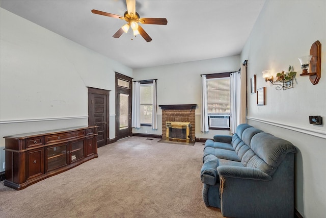 carpeted living room with a brick fireplace, ceiling fan, and cooling unit