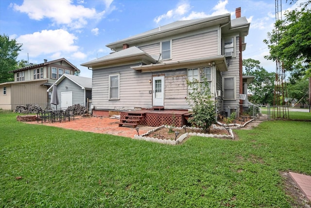 rear view of house featuring a yard and a patio