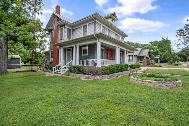 view of front of house featuring covered porch and a front yard