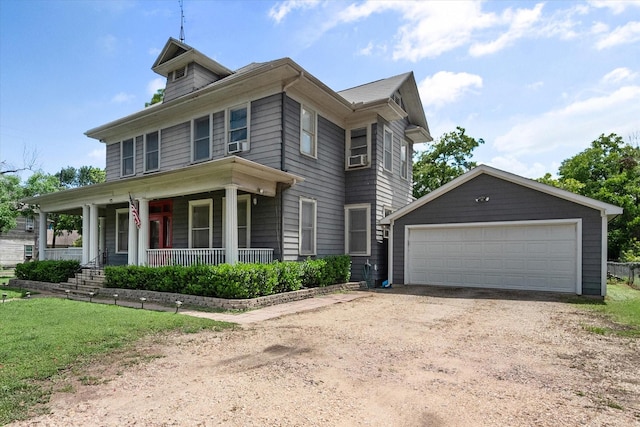 view of front of property with covered porch, a garage, and an outdoor structure