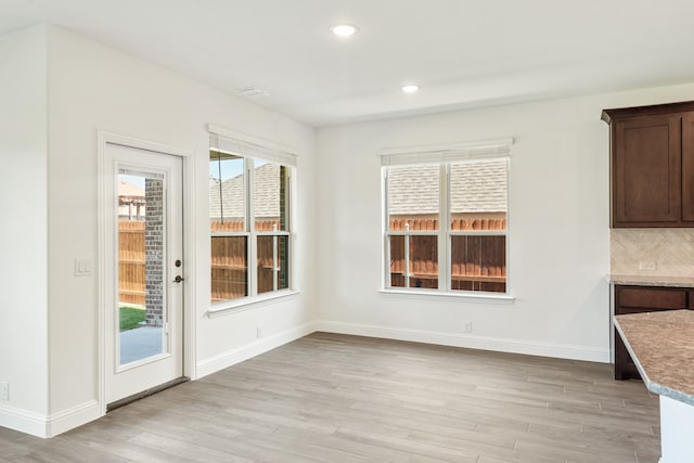 unfurnished dining area featuring light hardwood / wood-style floors