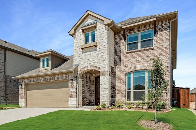 view of front of property with a front yard and a garage