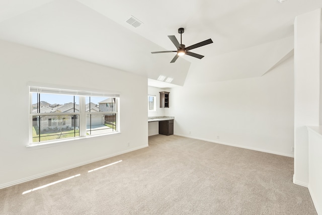 unfurnished living room featuring light carpet, lofted ceiling, and ceiling fan