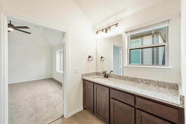 bathroom with lofted ceiling, vanity, ceiling fan, and tile patterned floors