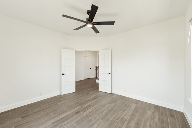 spare room with light hardwood / wood-style flooring and ceiling fan