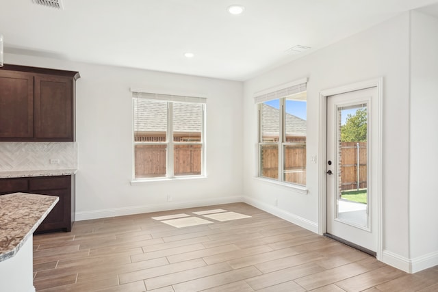 unfurnished dining area featuring light hardwood / wood-style flooring