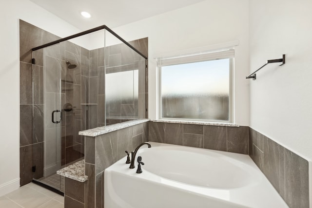 bathroom featuring tile patterned floors and separate shower and tub