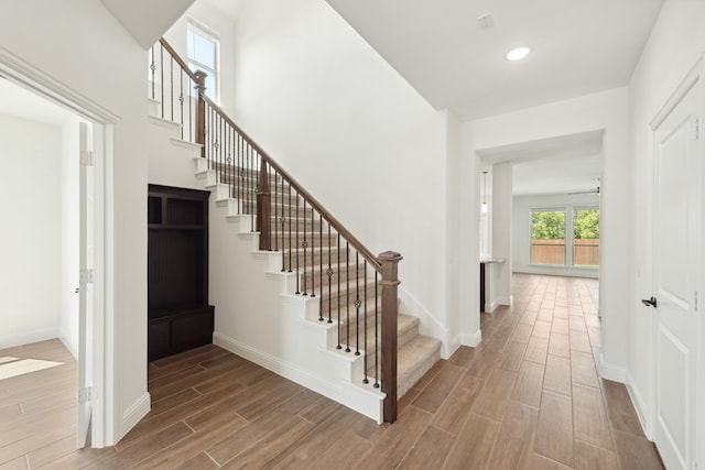 staircase featuring wood-type flooring