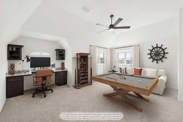 recreation room featuring light carpet, built in desk, lofted ceiling, and ceiling fan