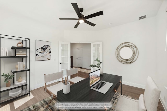 office space featuring wood-type flooring, ceiling fan, and french doors