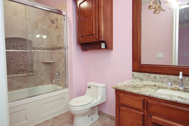 bathroom with shower / bath combination with glass door, toilet, vanity, and tile patterned floors