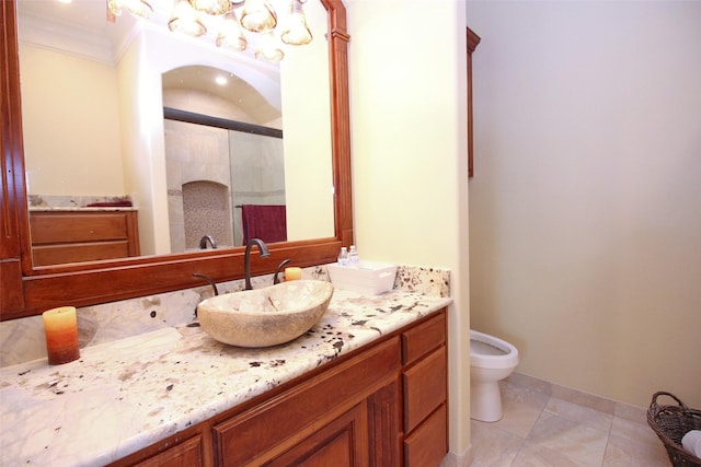 bathroom with toilet, a stall shower, crown molding, tile patterned flooring, and vanity