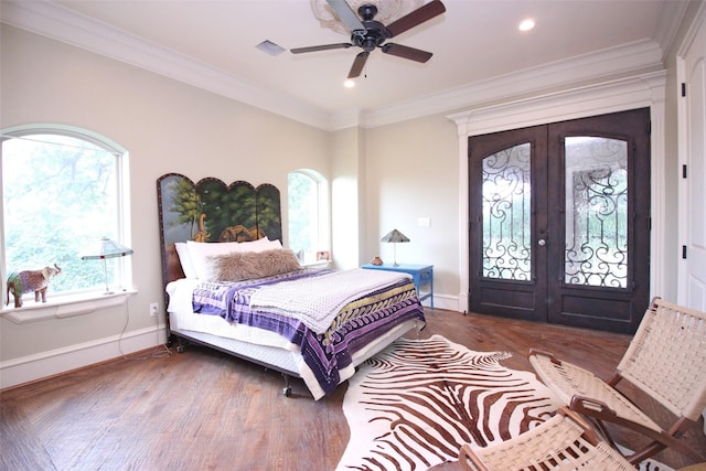 bedroom with wood finished floors, baseboards, french doors, crown molding, and access to outside