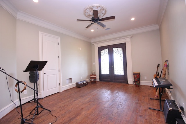 entrance foyer with french doors, dark hardwood / wood-style floors, ornamental molding, and ceiling fan