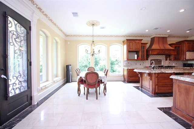 kitchen with visible vents, custom exhaust hood, and decorative backsplash