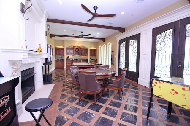 dining space featuring ceiling fan, beamed ceiling, recessed lighting, a fireplace, and arched walkways