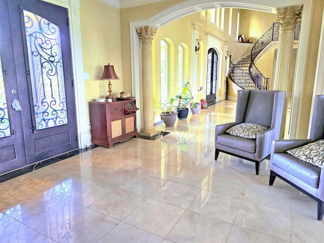 interior space featuring ornate columns, ornamental molding, french doors, and tile floors